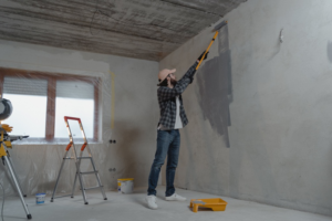 Man painting the interior walls of his house