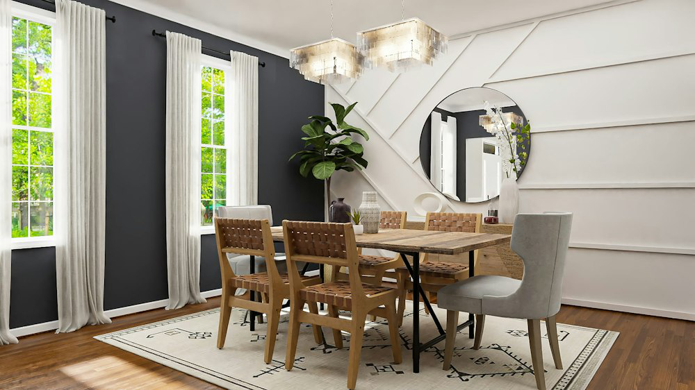 A dining room of a house with a wooden floor and accent walls