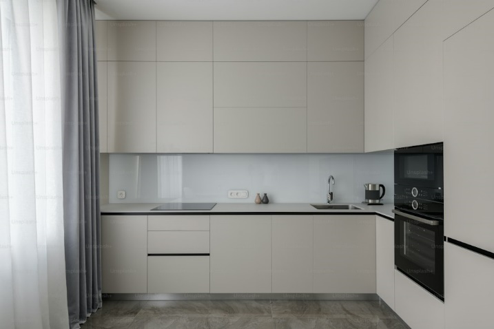 A kitchen with beige-coloured cabinets